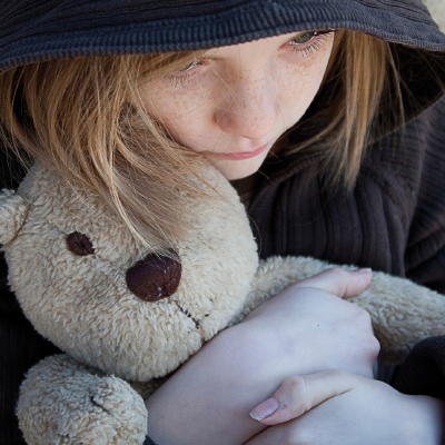 Image of a young girl hugging a teddybear